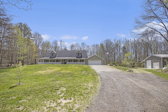 cape cod home with a porch, a front lawn, and a detached garage