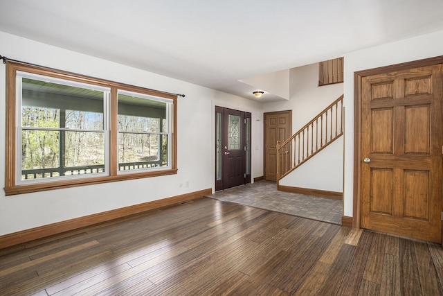 foyer with stairway, baseboards, and wood-type flooring