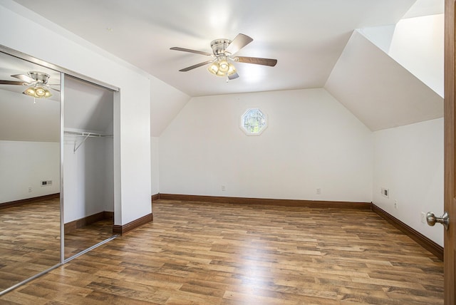 additional living space featuring a ceiling fan, vaulted ceiling, and wood finished floors