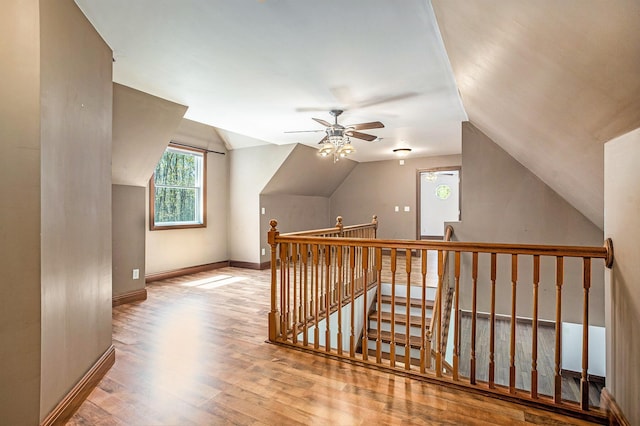 bonus room with baseboards, a ceiling fan, wood finished floors, and vaulted ceiling