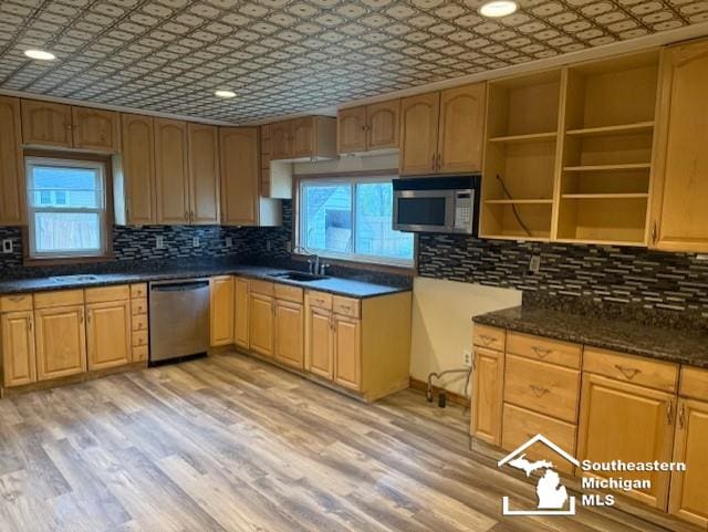 kitchen featuring an ornate ceiling, appliances with stainless steel finishes, and plenty of natural light