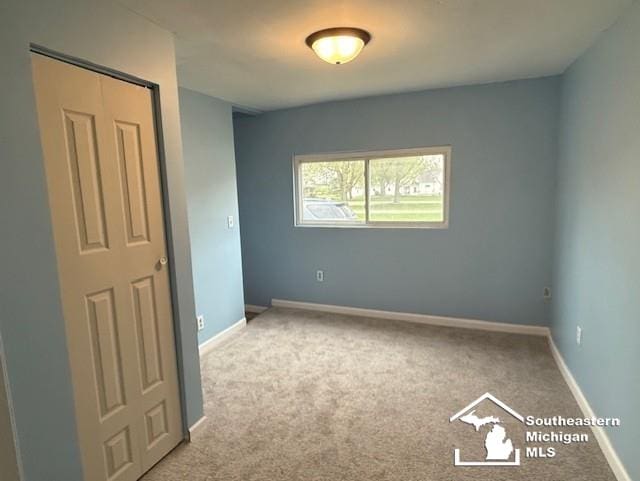 unfurnished bedroom featuring baseboards and carpet