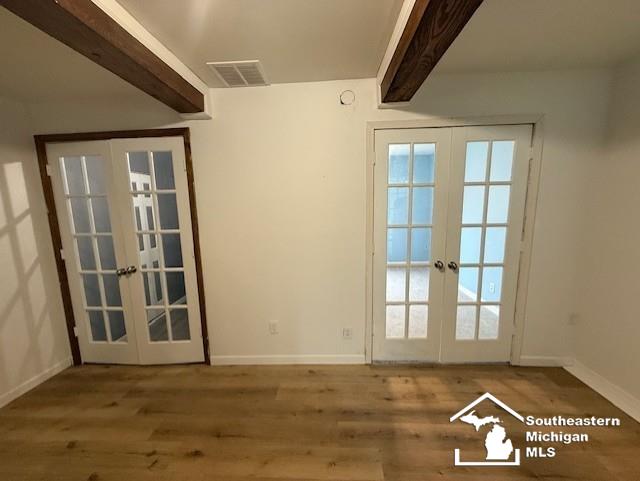 entryway with baseboards, visible vents, and french doors