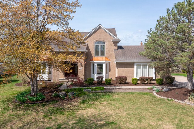 3351 Muerknoll Dr, Troy, MI 48084 - traditional-style house featuring roof with shingles, a front lawn, and brick siding