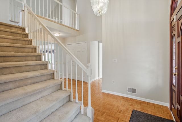 3351 Muerknoll Dr, Troy, MI 48084 - foyer featuring baseboards, visible vents, stairway, and a towering ceiling