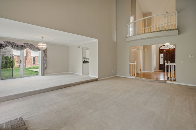 3351 Muerknoll Dr, Troy, MI 48084 - unfurnished living room featuring carpet floors, a chandelier, baseboards, a towering ceiling, and visible vents