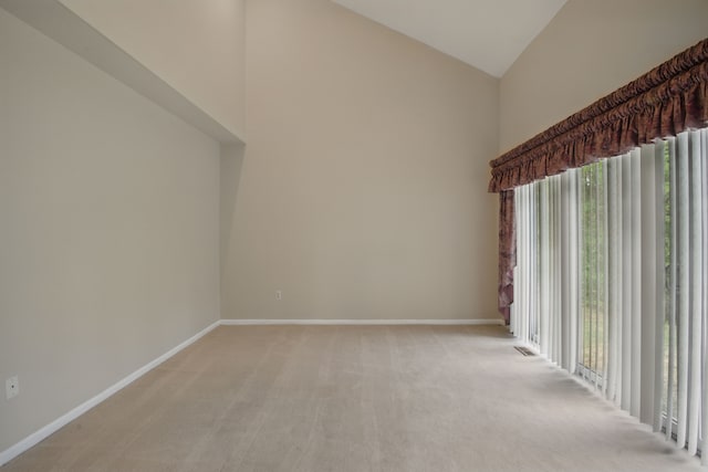 3351 Muerknoll Dr, Troy, MI 48084 - spare room featuring high vaulted ceiling, baseboards, and light carpet