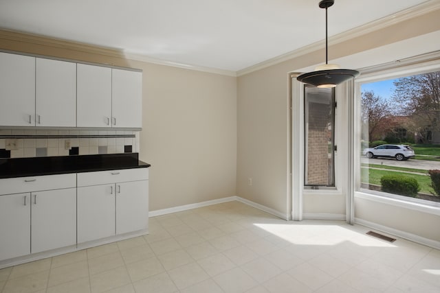 3351 Muerknoll Dr, Troy, MI 48084 - kitchen with visible vents, dark countertops, baseboards, white cabinets, and ornamental molding