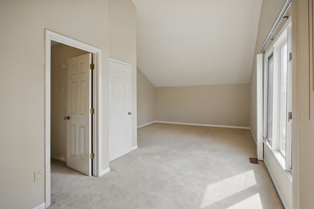 3351 Muerknoll Dr, Troy, MI 48084 - additional living space with vaulted ceiling, light carpet, and a healthy amount of sunlight