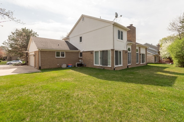 3351 Muerknoll Dr, Troy, MI 48084 - rear view of house with central air condition unit, brick siding, a chimney, a lawn, and driveway