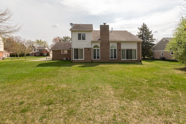 3351 Muerknoll Dr, Troy, MI 48084 - back of house with a lawn, brick siding, central AC, and a chimney