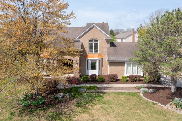 3351 Muerknoll Dr, Troy, MI 48084 - traditional-style house with roof with shingles, a front yard, and brick siding