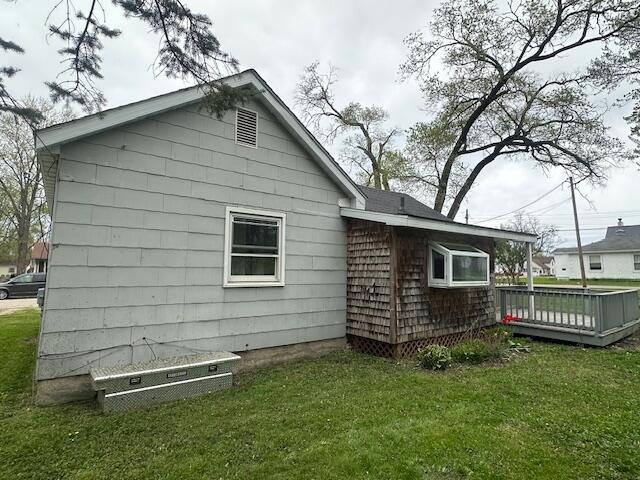 back of house with a lawn and a deck
