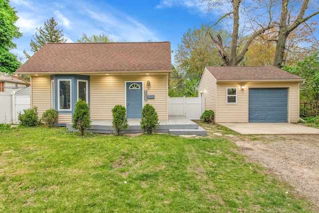 view of front of property featuring an outdoor structure, fence, a wooden deck, driveway, and a detached garage