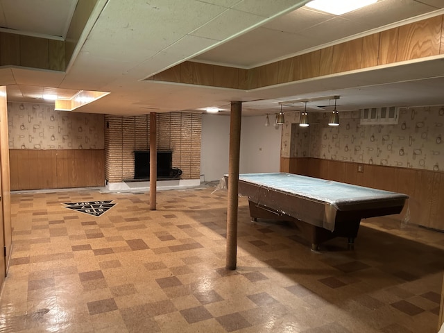 finished basement with wallpapered walls, wood walls, wainscoting, and light floors
