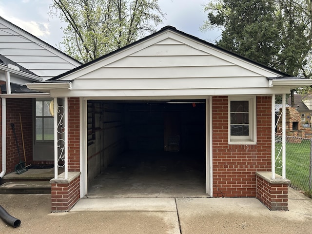 garage with fence and driveway