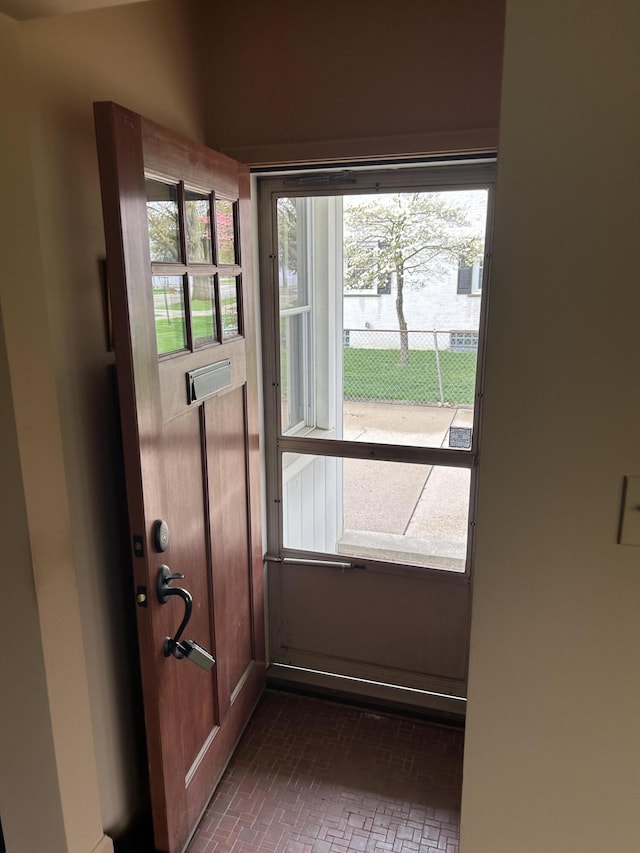 entryway featuring brick patterned floor