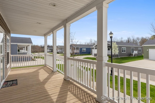 deck with covered porch and a residential view