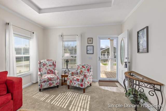 sitting room featuring crown molding, baseboards, and a wealth of natural light