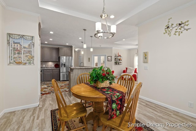 dining room featuring recessed lighting, baseboards, an inviting chandelier, and light wood finished floors