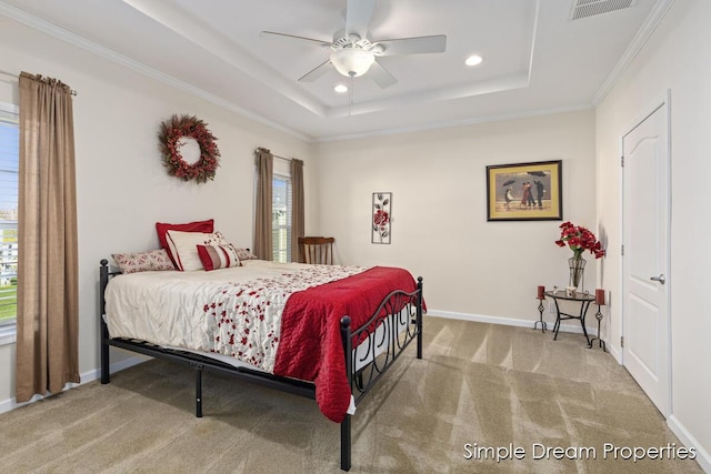 carpeted bedroom featuring visible vents, a raised ceiling, baseboards, ornamental molding, and recessed lighting