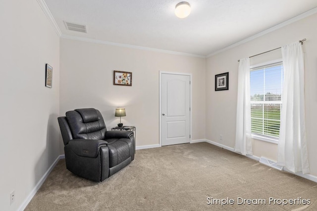 sitting room featuring baseboards, visible vents, ornamental molding, and carpet