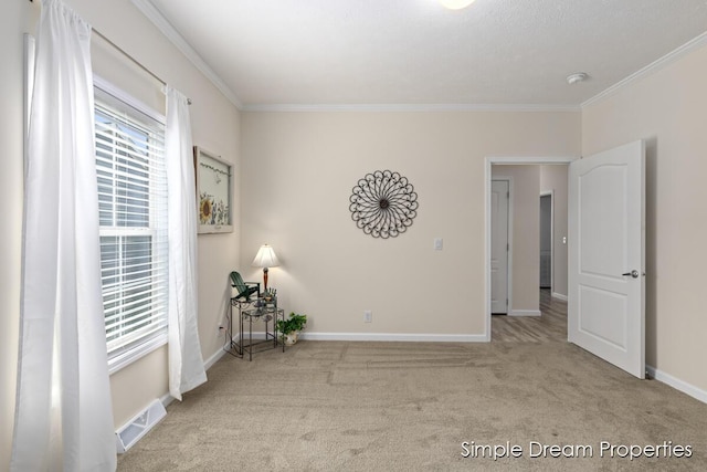 unfurnished room featuring carpet floors, ornamental molding, baseboards, and visible vents