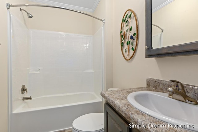 bathroom featuring vanity, ornamental molding, bathtub / shower combination, and toilet