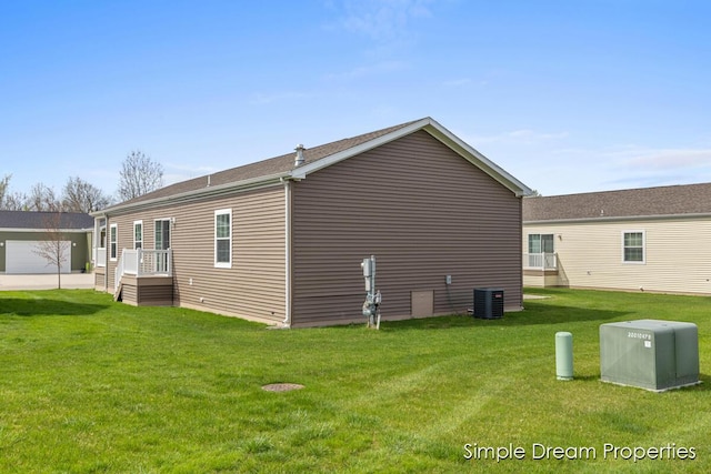 view of home's exterior featuring a lawn and central AC unit