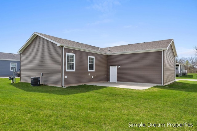back of house featuring a lawn, a patio, and central air condition unit