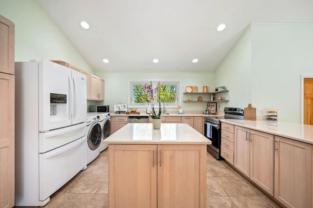 19117 Beaver Dam Rd, Galien, MI 49113 - kitchen with washing machine and dryer, light brown cabinets, light countertops, appliances with stainless steel finishes, and vaulted ceiling