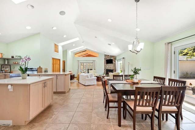 19117 Beaver Dam Rd, Galien, MI 49113 - dining room with a fireplace, vaulted ceiling, and light tile patterned flooring