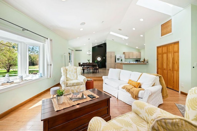 19117 Beaver Dam Rd, Galien, MI 49113 - living area with light wood-style floors, recessed lighting, baseboards, visible vents, and lofted ceiling with skylight