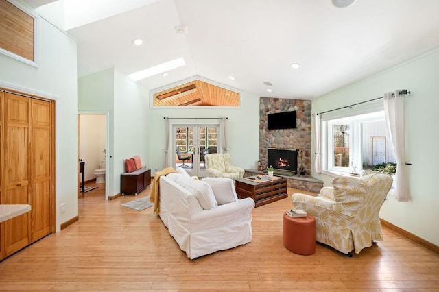 19117 Beaver Dam Rd, Galien, MI 49113 - living area with plenty of natural light, french doors, vaulted ceiling with skylight, and light wood-style floors