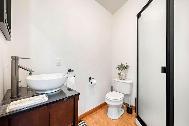 19117 Beaver Dam Rd, Galien, MI 49113 - bathroom featuring vanity, toilet, baseboards, wood finished floors, and vaulted ceiling