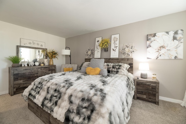 carpeted bedroom featuring baseboards