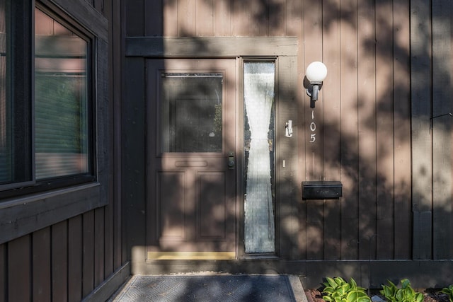 doorway to property featuring board and batten siding