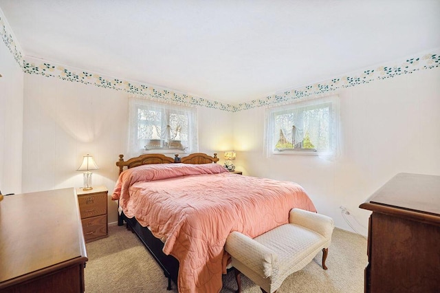 bedroom featuring multiple windows and light carpet