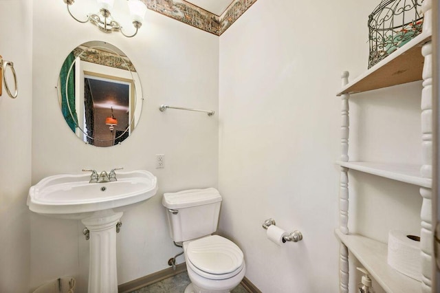 half bath with toilet and baseboards