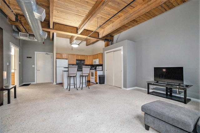living room with visible vents, beam ceiling, light carpet, baseboards, and wood ceiling