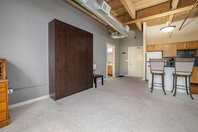 kitchen with dark countertops, decorative light fixtures, wooden ceiling, beamed ceiling, and visible vents