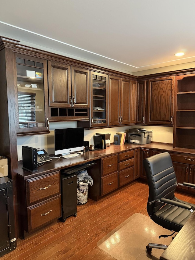 office with built in study area, recessed lighting, and wood finished floors