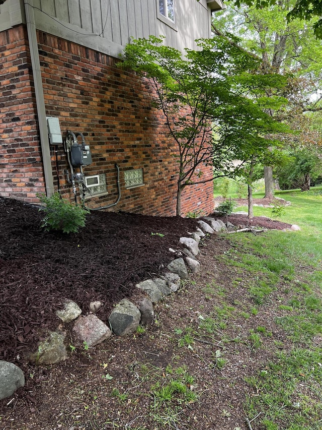 view of side of home featuring brick siding