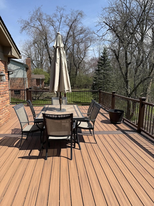 wooden terrace with outdoor dining area