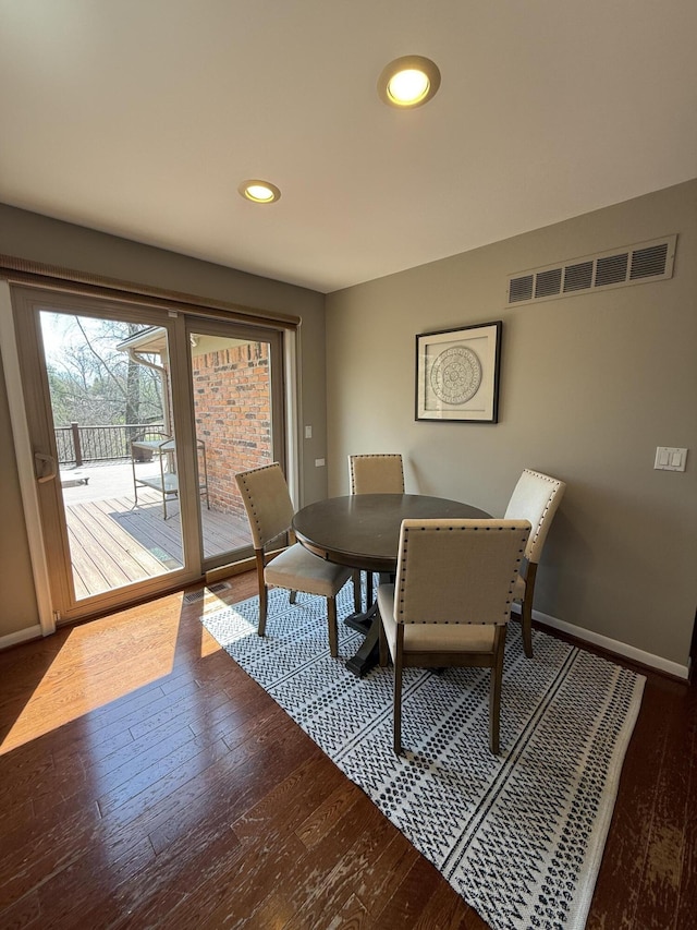 dining space with recessed lighting, baseboards, visible vents, and hardwood / wood-style flooring