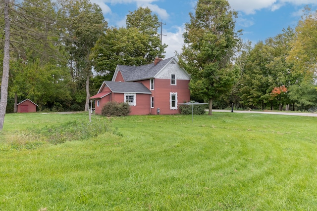 50505 Geddes Rd, Canton, MI 48188 - view of home's exterior with a chimney, roof with shingles, an outbuilding, a shed, and a yard