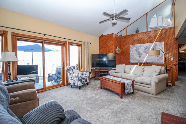 carpeted living area featuring a ceiling fan and high vaulted ceiling