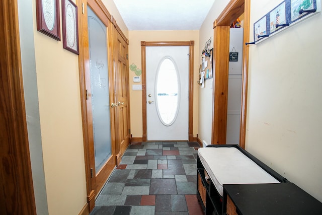 doorway featuring baseboards and stone finish flooring
