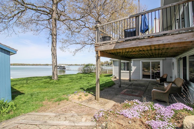 view of yard with a deck with water view and a patio area