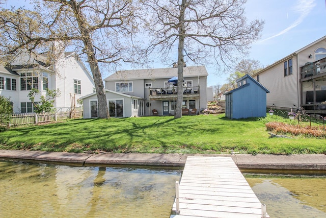 dock area with a yard and fence
